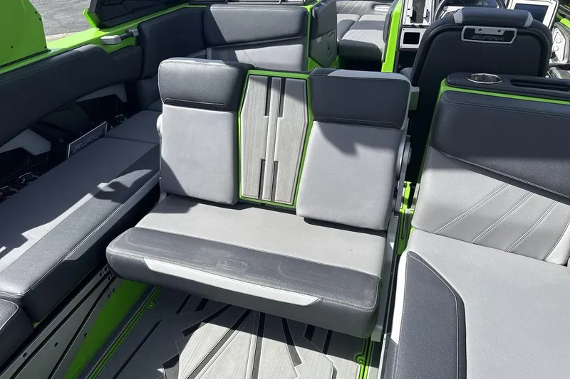 Slide: The Image of 2022 Supra SA 450 boat interior with gray and green seating. - 24
