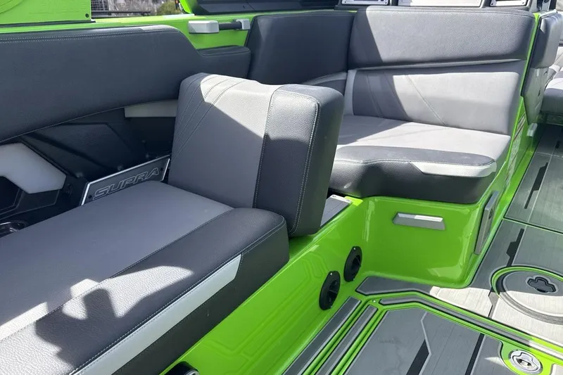 Slide: The Image of 2022 Supra SA 450 boat interior with green and gray seating, showcasing modern design. - 25
