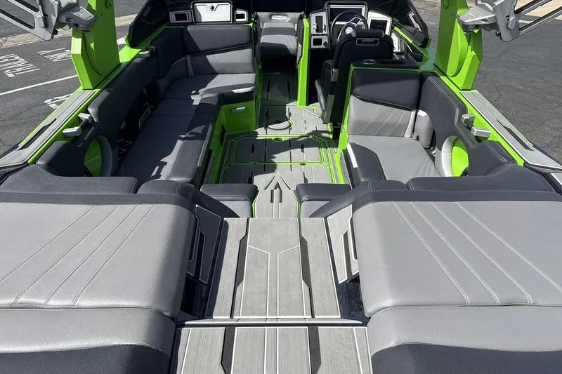 Slide: The Image of Interior of 2022 Supra SA 450 boat with sleek gray and green seating. - 9