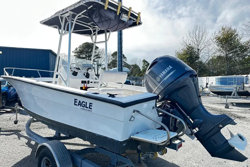 Slide: The Image of 2004 Angler Eagle Center Console boat with Yamaha outboard motor on a trailer. - 2