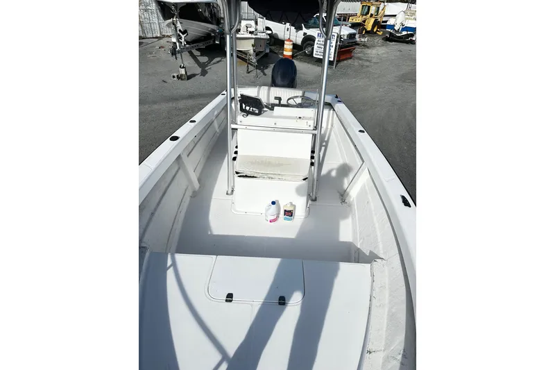 Slide: The Image of 2004 Angler Eagle Center Console boat with clean deck and storage compartments. - 3
