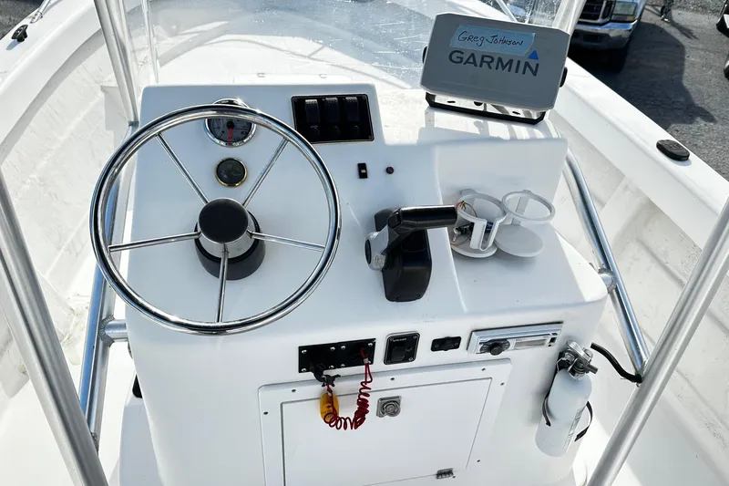 Slide: The Image of 2004 Angler Eagle Center Console boat dashboard with Garmin GPS and steering wheel. - 5