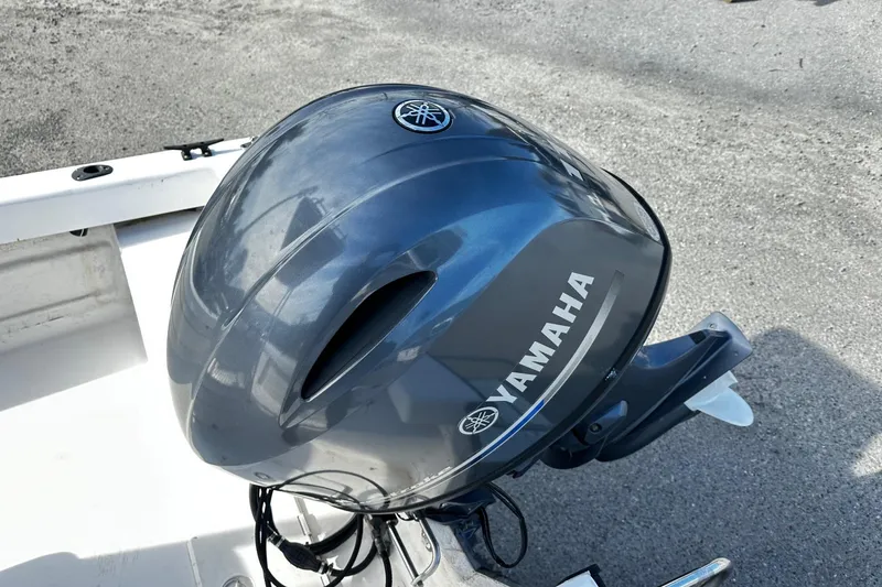 Slide: The Image of 2004 Angler Eagle Center Console with Yamaha outboard motor on a boat deck. - 8