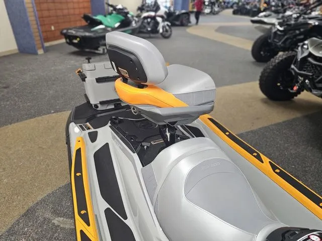 Slide: The Image of 2026 Sea-Doo FISH PRO jet ski in showroom, gray and orange details. - 13