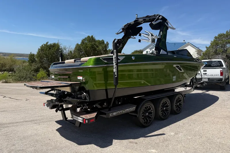 Slide: The Image of 2021 Centurion Ri245 boat on trailer, green exterior, parked outdoors. - 15