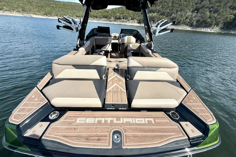 Slide: The Image of 2021 Centurion Ri245 boat with luxurious seating on a serene lake. - 18