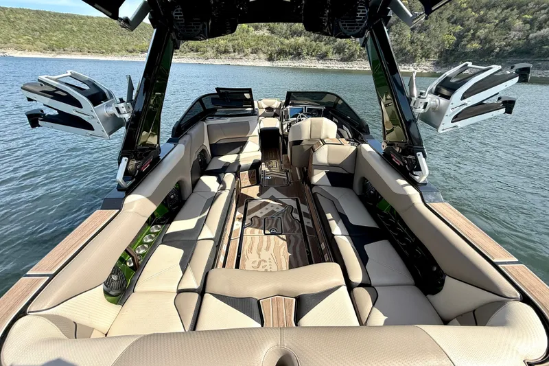 Slide: The Image of Luxurious interior of a 2021 Centurion Ri245 boat on a serene lake. - 19