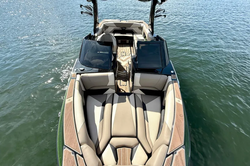 Slide: The Image of 2021 Centurion Ri245 boat with luxurious seating on calm water. - 21