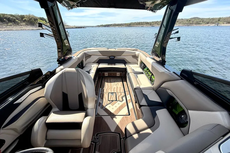 Slide: The Image of Luxurious interior of a 2021 Centurion Ri245 boat on a serene lake. - 22