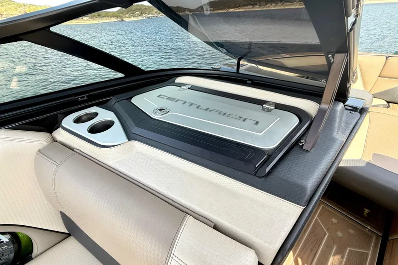 Slide: The Image of 2021 Centurion Ri245 boat interior with storage compartment and cup holders. - 26