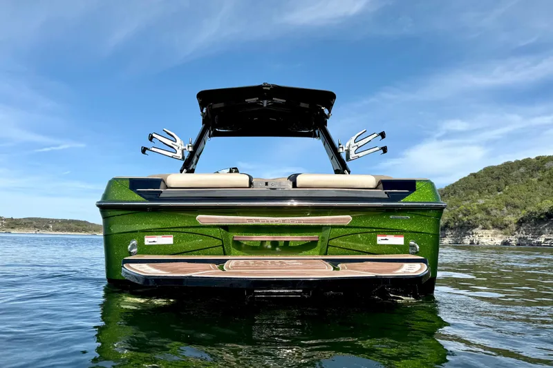 Slide: The Image of 2021 Centurion Ri245 boat on water, green exterior, sunny day, scenic background. - 5