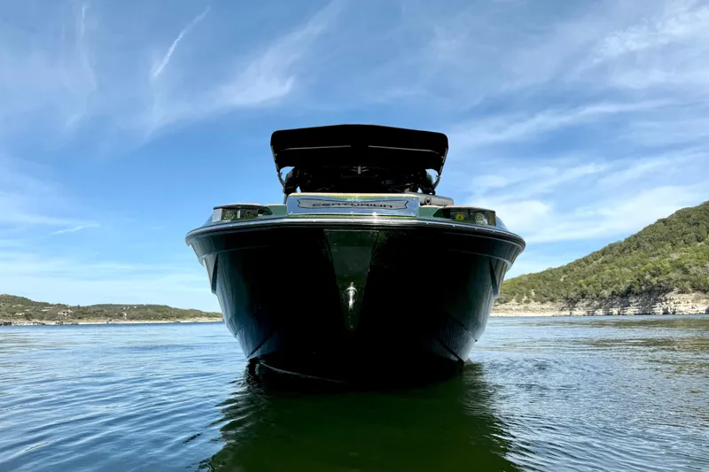 Slide: The Image of 2021 Centurion Ri245 boat on calm water with scenic background. - 9