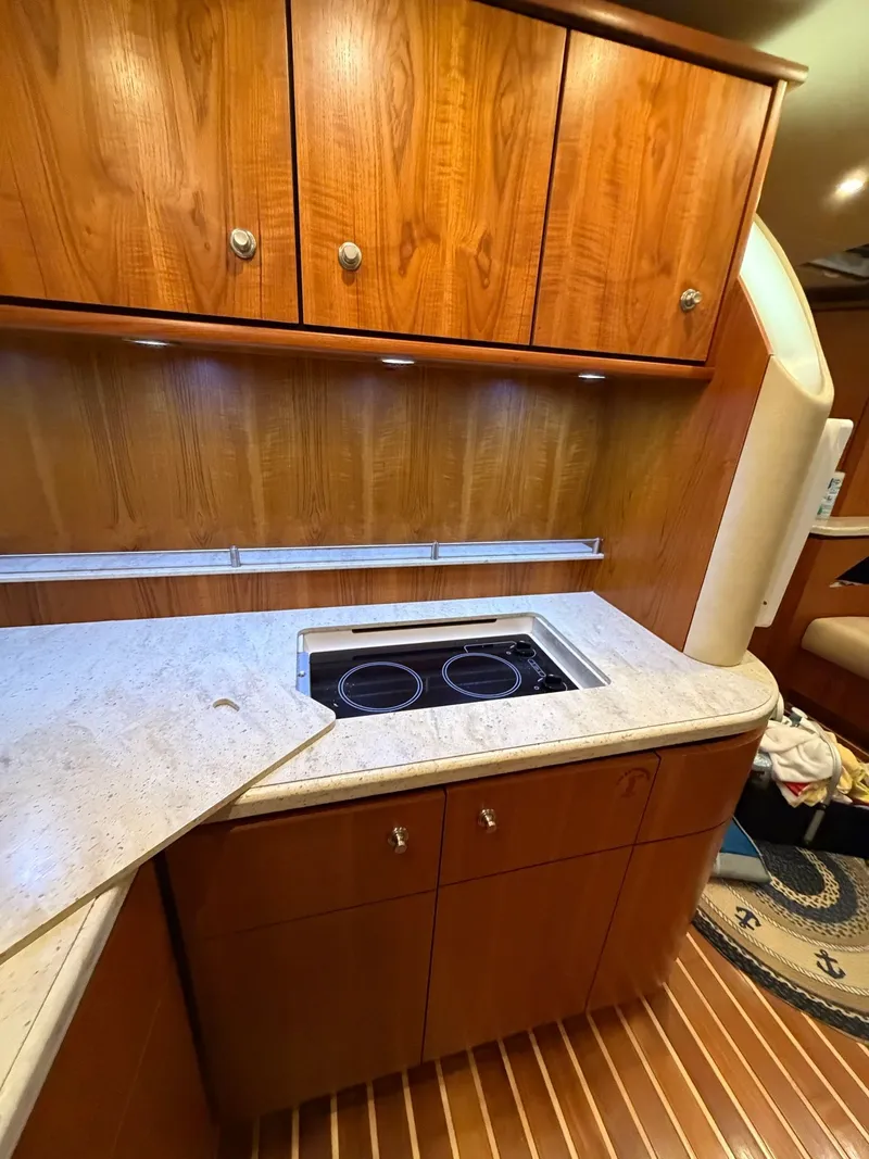 Slide: The Image of Interior of 2009 Tiara Yachts 4300 Sovran with leather seating and wooden table. - 47