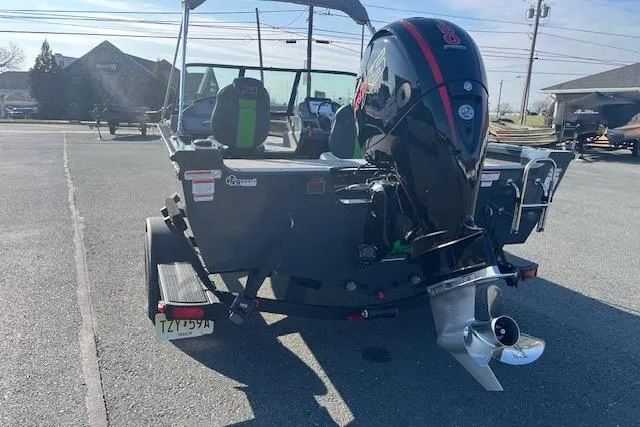 Slide: The Image of 2023 Ranger VS1782SC Reata boat with powerful outboard motor in a parking lot. - 15