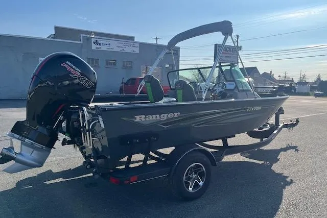 The Image of 2023 Ranger VS1782SC Reata boat with outboard motor, parked outdoors on a sunny day. - 3