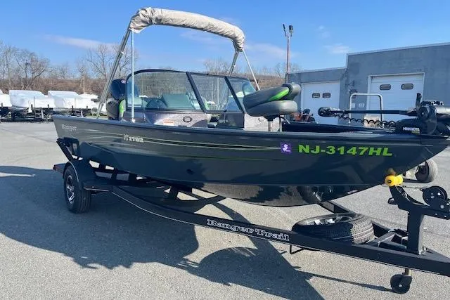 Slide: The Image of 2023 Ranger VS1782SC Reata boat on trailer, parked outdoors, with registration NJ-3147HL. - 5