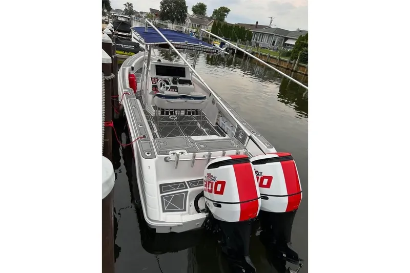 Slide: The Image of 2001 Donzi 35 ZF boat with twin outboard engines docked in a marina. - 16