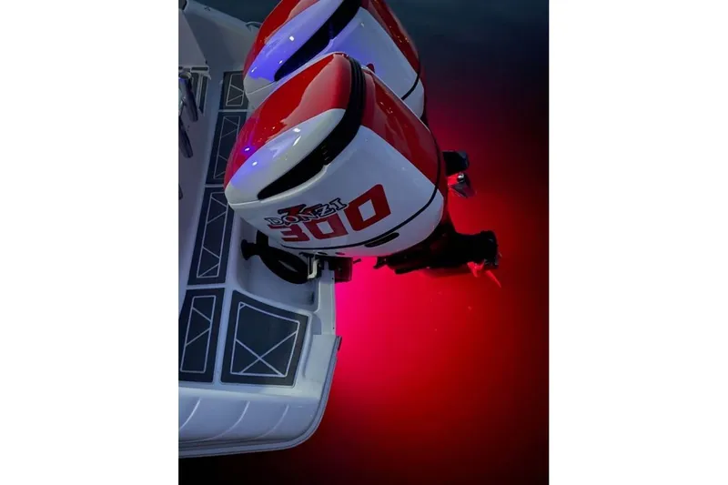 Slide: The Image of Twin outboard engines on a 2001 Donzi 35 ZF boat, illuminated by red underwater lights. - 17