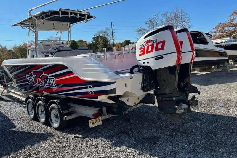 Slide: The Image of 2001 Donzi 35 ZF boat with twin 300 horsepower engines on a trailer. - 2
