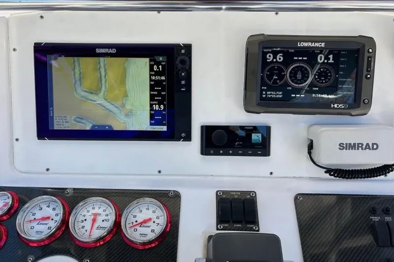 Slide: The Image of Dashboard of a 2001 Donzi 35 ZF boat with Livorsi gauges and carbon fiber panel. - 6