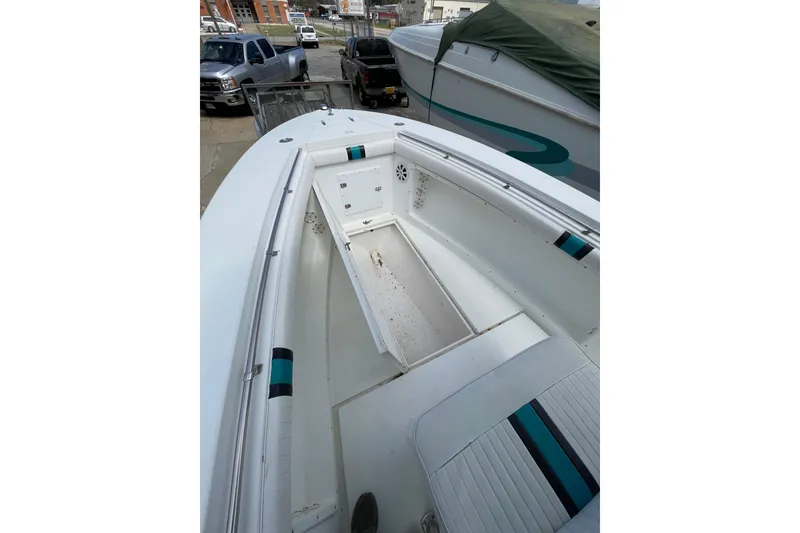 Slide: The Image of 1999 Contender 23 Open boat interior with seating and storage compartments. - 23