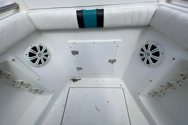 Slide: The Image of Interior of a 1999 Contender 23 Open boat, featuring speakers and storage compartments. - 25
