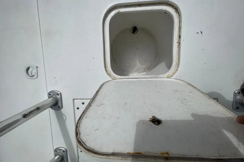 Slide: The Image of Open storage compartment on a 1999 Contender 23 Open boat. - 28