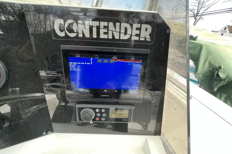 Slide: The Image of Dashboard of a 1999 Contender 23 Open boat with Garmin navigation display. - 29
