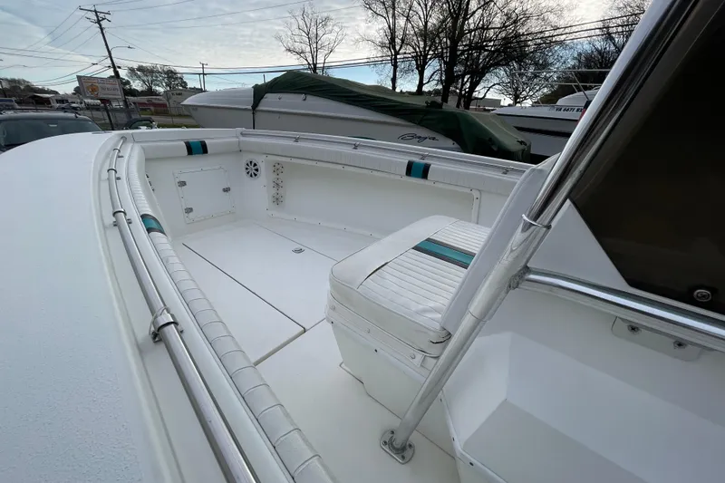 Slide: The Image of 1999 Contender 23 CC boat interior with seating and storage compartments. - 5