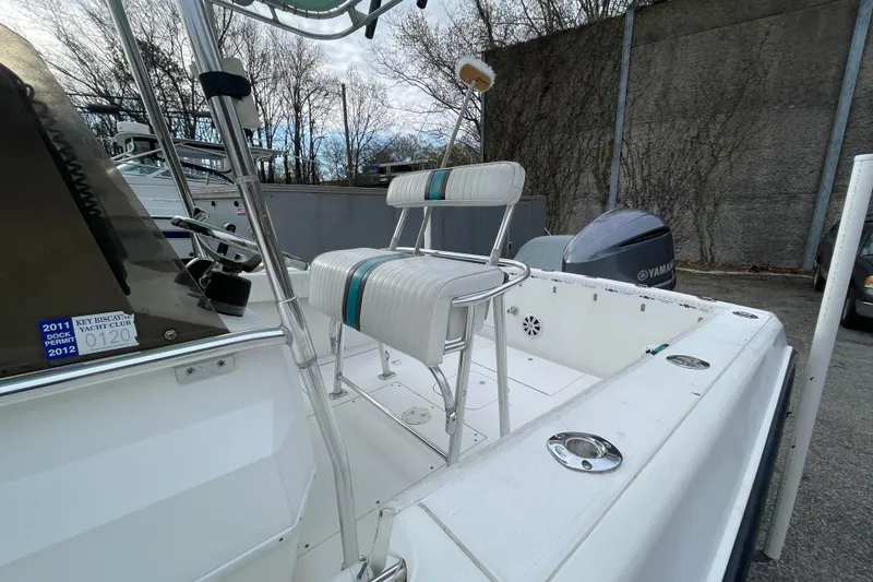 Slide: The Image of 1999 Contender 23 CC boat with Yamaha engine, docked outdoors. - 6