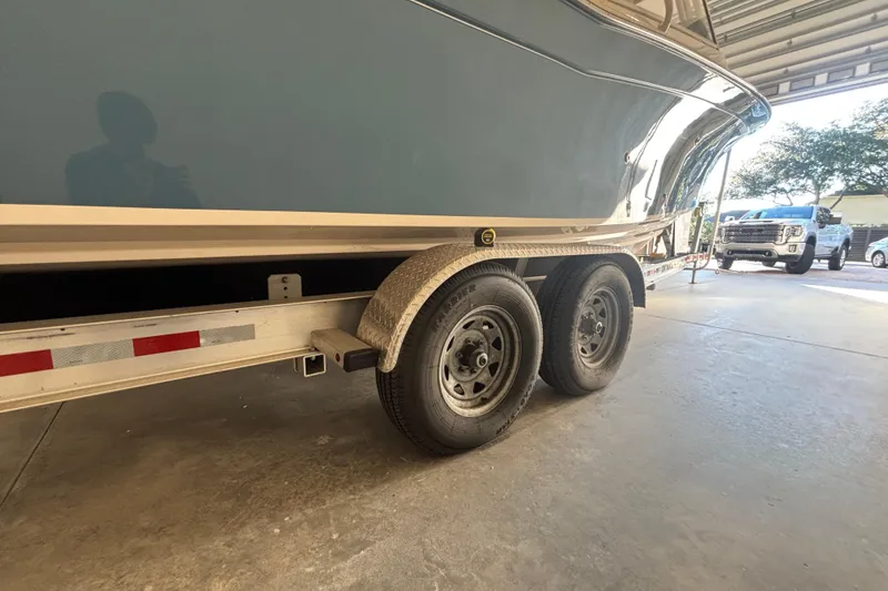 Slide: The Image of 2022 Grady-White Freedom 275 boat on trailer in garage setting. - 1