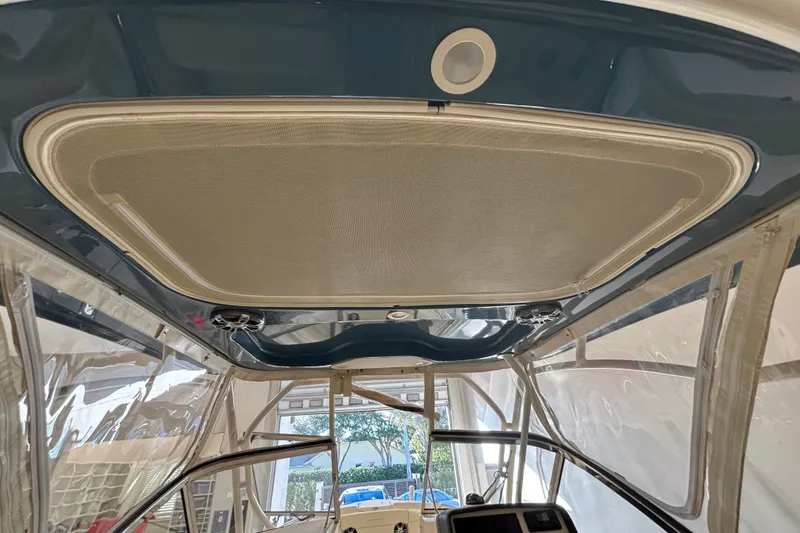 Slide: The Image of 2022 Grady-White Freedom 275 boat interior with sunroof and clear side panels. - 11