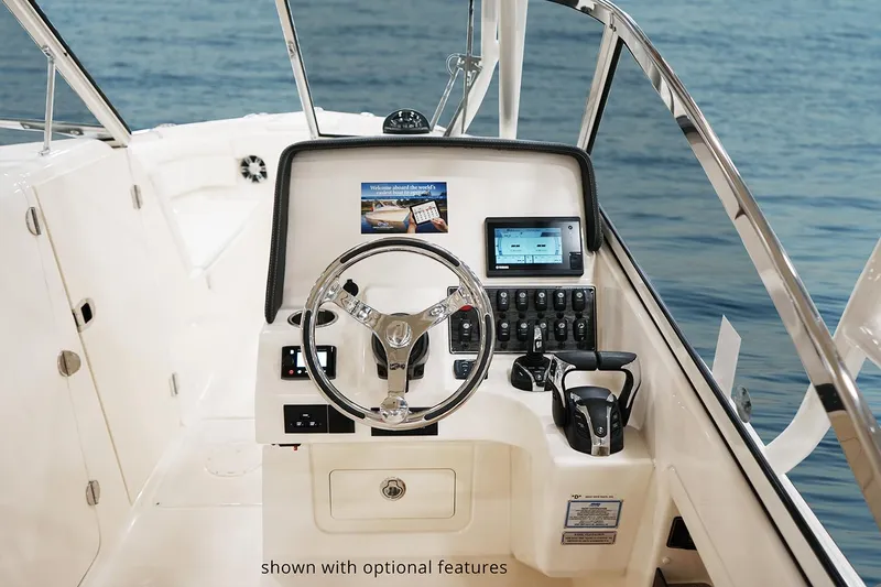Slide: The Image of Manufacturer Provided Image: 2022 Grady-White Freedom 275 boat helm with optional features, steering wheel, and navigation controls. - 14