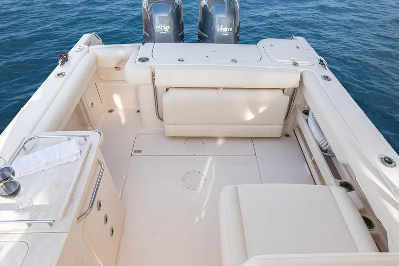 Slide: The Image of Manufacturer Provided Image: 2022 Grady-White Freedom 275 boat interior with twin engines and spacious seating. - 17