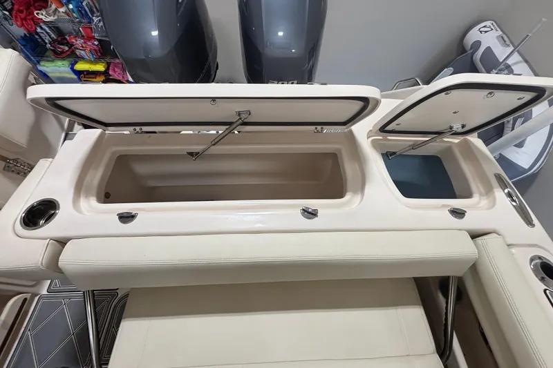 Slide: The Image of Open storage compartments on a 2022 Grady-White Freedom 275 boat interior. - 18