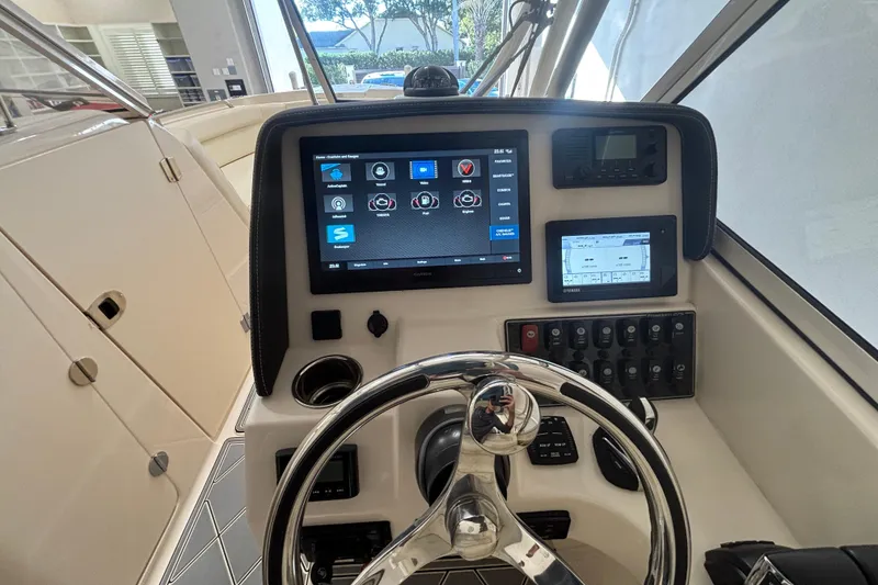 Slide: The Image of 2022 Grady-White Freedom 275 boat dashboard with modern navigation and control systems. - 2