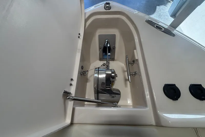Slide: The Image of Anchor compartment of 2022 Grady-White Freedom 275 boat, featuring stainless steel hardware. - 21