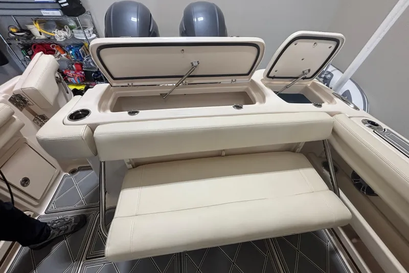 Slide: The Image of 2022 Grady-White Freedom 275 boat interior with open storage compartments and seating. - 27