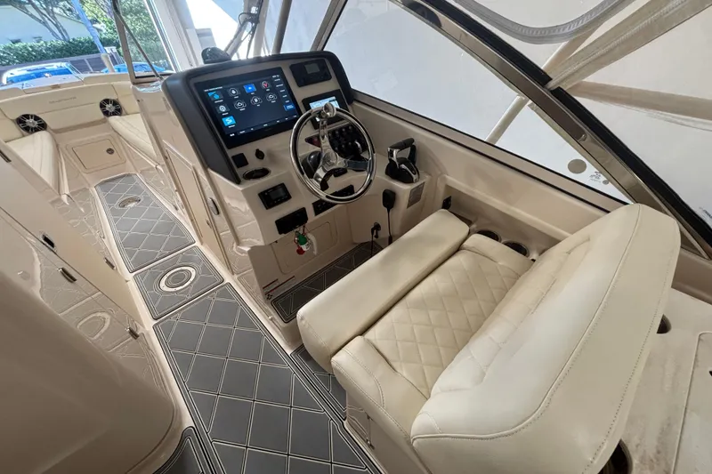 Slide: The Image of 2022 Grady-White Freedom 275 boat interior with modern dashboard and plush seating. - 29