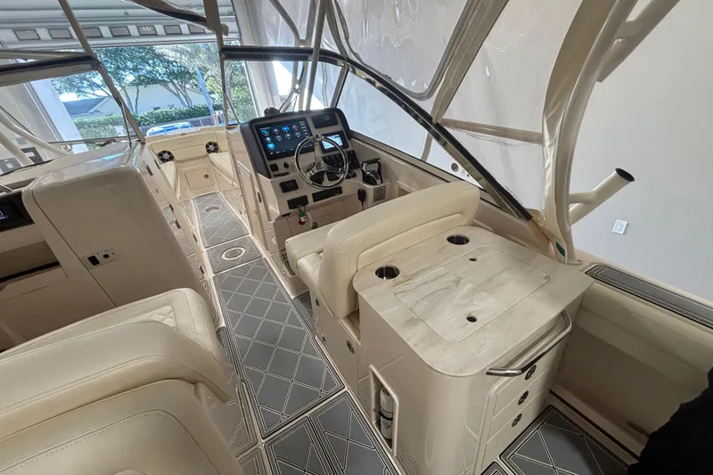 Slide: The Image of 2022 Grady-White Freedom 275 boat interior with modern dashboard and seating. - 4