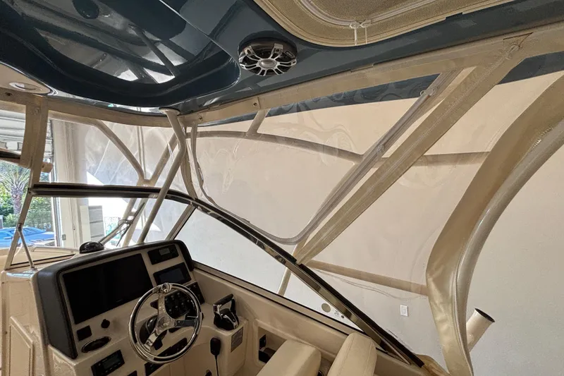 Slide: The Image of Interior view of 2022 Grady-White Freedom 275 boat, showcasing helm and seating area. - 8