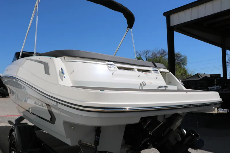 Slide: The Image of 2022 Bayliner VR5 Bowrider I/O boat, rear view, parked outdoors under clear blue sky. - 10