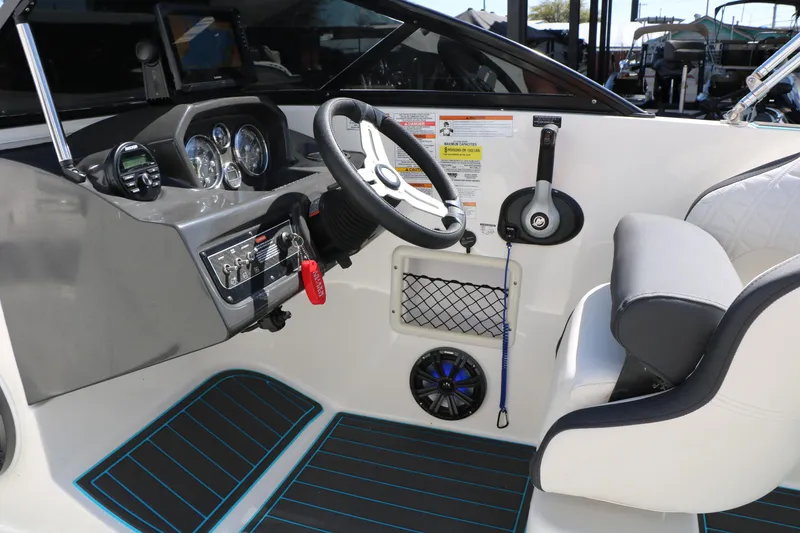 Slide: The Image of 2022 Bayliner VR5 Bowrider I/O cockpit with steering wheel, controls, and seating. - 27