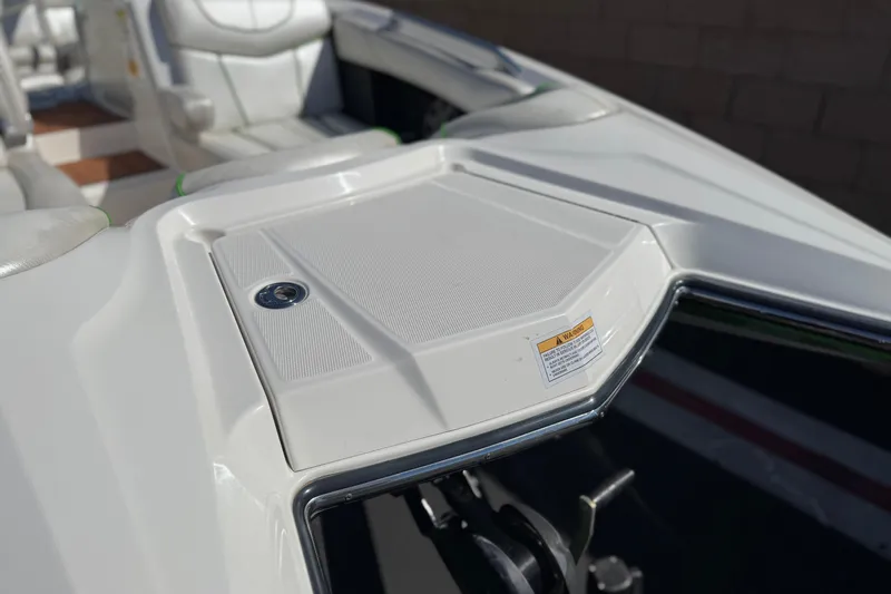 Slide: The Image of 2013 MasterCraft XStar boat interior with white seating and sleek design. - 11