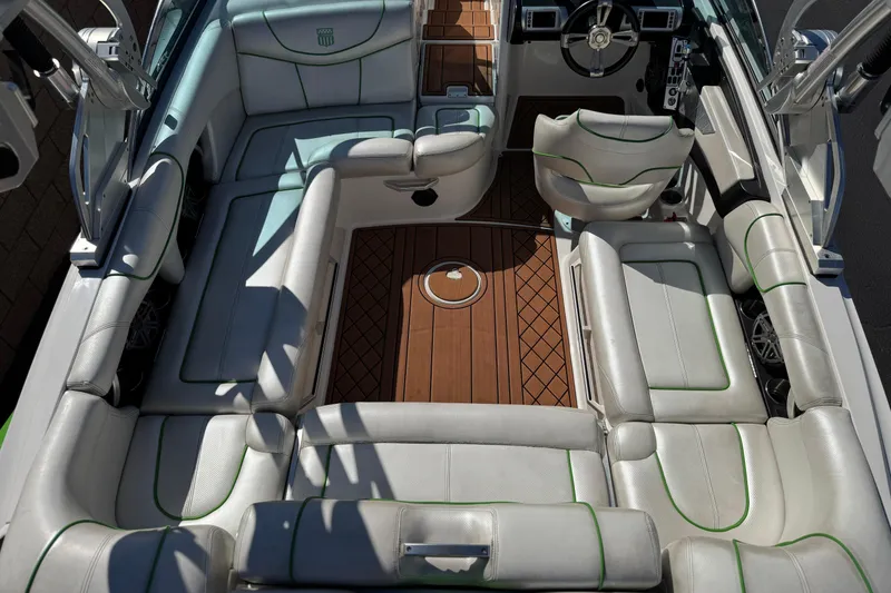 Slide: The Image of 2013 MasterCraft XStar interior with white seating and wooden flooring. - 15