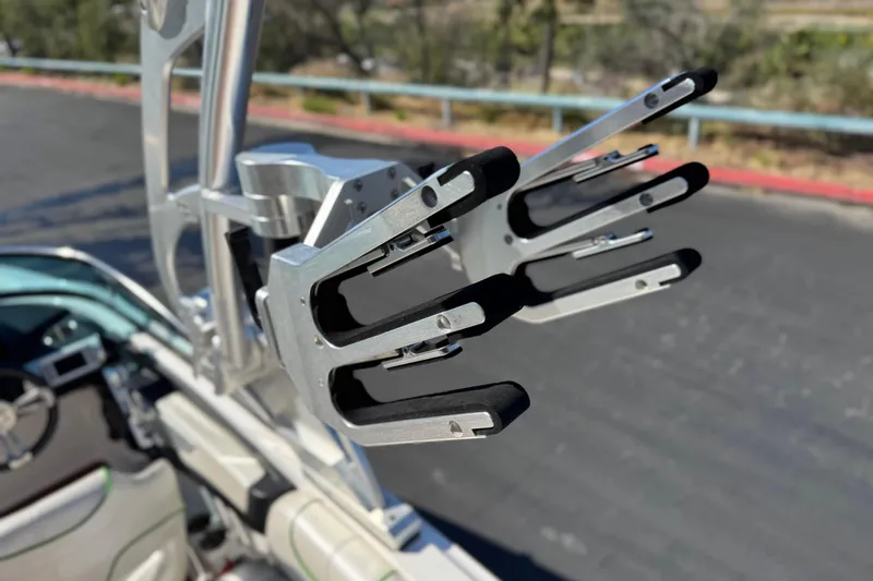 Slide: The Image of 2013 MasterCraft XStar wakeboard rack with padded slots, mounted on a boat. - 19