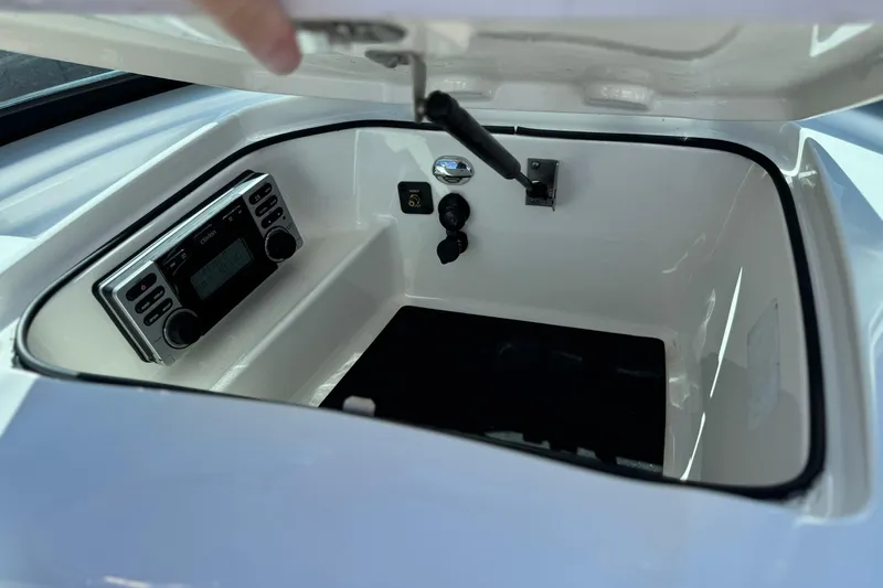 Slide: The Image of 2013 MasterCraft XStar storage compartment with stereo system and control panel. - 29