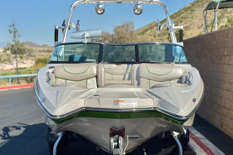 Slide: The Image of 2013 MasterCraft XStar boat with sleek design, parked outdoors on a sunny day. - 3