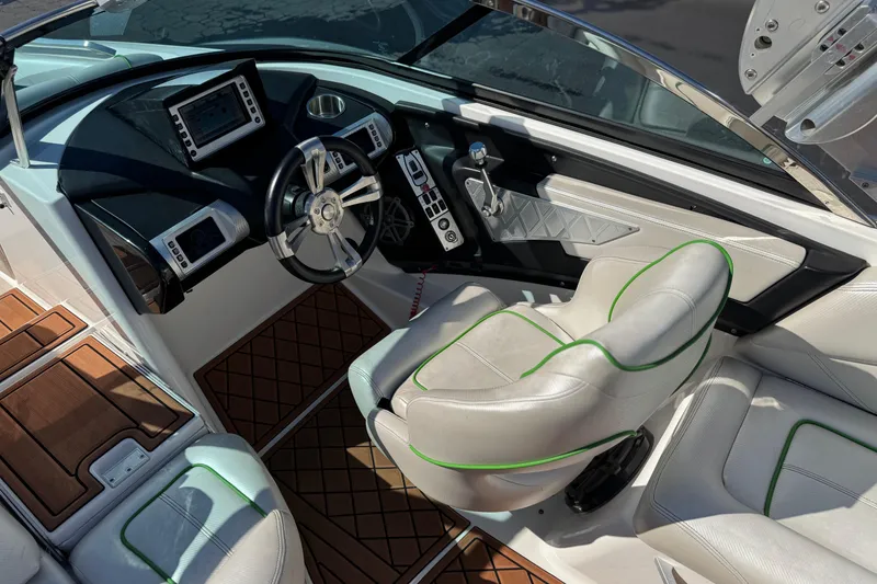 Slide: The Image of 2013 MasterCraft XStar boat interior with modern dashboard and leather seating. - 30