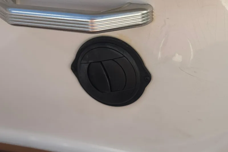 Slide: The Image of Close-up of a 2013 MasterCraft XStar boat handle and circular vent. - 34